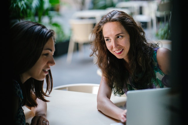 two-talking-women-while-using-laptop-1311547